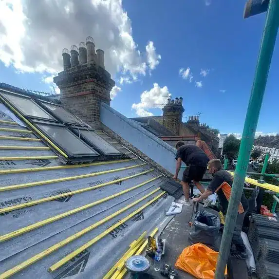 Roofing company London team at work on a roof